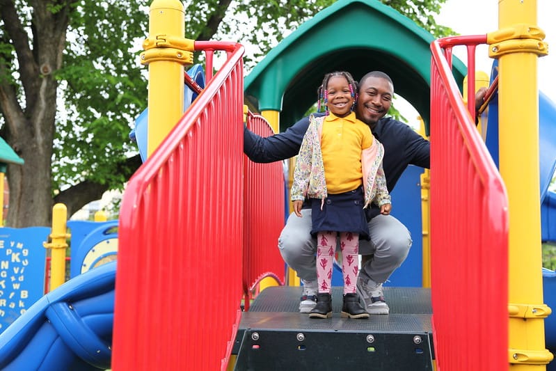 Mr. Walcott joins his daughter on her school playground.