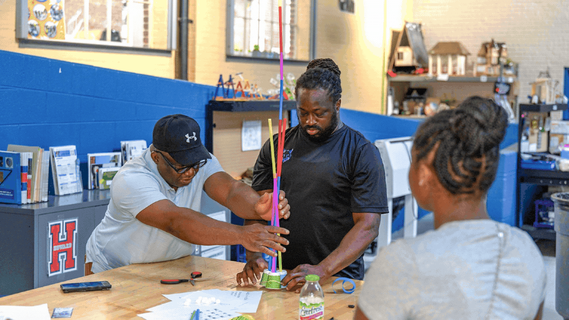 Family Math Dinners Two teachers building a straw tower.